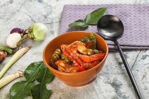 A bowl of food with vegetables and shrimp photo