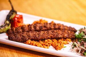 A plate with meat and rice on it photo