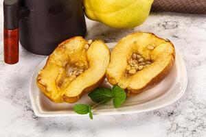 A white plate topped with a half of a pear photo