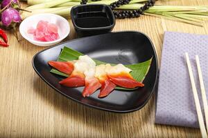 A plate of sushi with chopsticks and a napkin photo