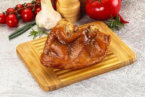 A piece of meat on a cutting board with vegetables and spices photo