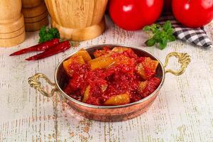 A bowl of tomato sauce with spices and tomatoes photo