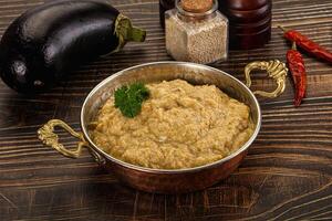 A bowl of food on a table next to a bowl of spices photo