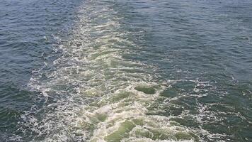 Close-up of water waves and foam, Detailed view of rippling water and foam created by a boat's wake video