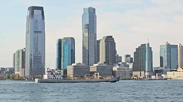 Jersey City, in Hudson County, City skyline with boat on water, Modern cityscape featuring tall skyscrapers, video