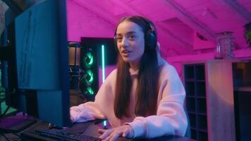 Stressed emotional upset sad Caucasian woman female girl user gamer streamer talking microphone talk to mic worried anxiety playing online game computer at night neon sport streaming web stream video