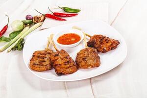 A plate of food with a sauce and vegetables photo