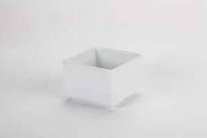 A white square container with a lid on a white surface photo