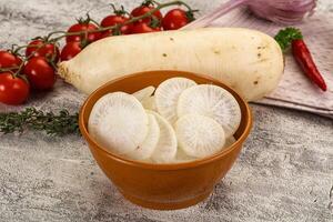 A bowl of white potatoes and tomatoes on a table photo