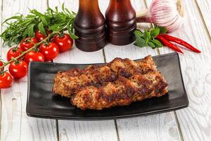 A plate with meat and vegetables on it photo