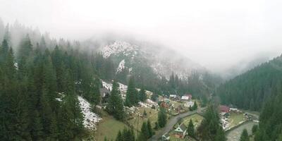 Top view of mist and village in clouds with green tree around, mountain village, cloud cover, greenery natural and tranquil village, foggy village scenic view, misty rural scene video