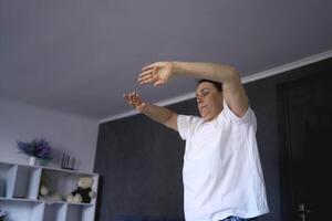 a senior woman performs somatic exercises, yoga at home ss photo