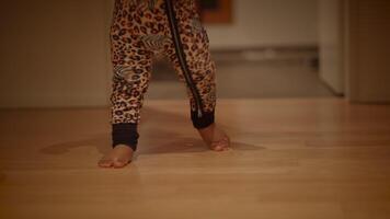 A Child Happily Playing Cheerfully While Dressed in Colorful Leopard Print Pajamas at Home video