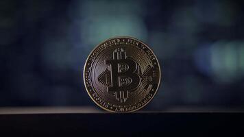A shiny Bitcoin coin stands out against a dark bokeh background, creating a striking visual video