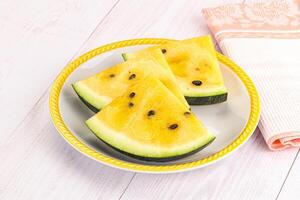 A plate with slices of watermelon on it photo