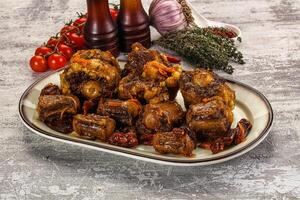 A plate of meat and vegetables on a table photo