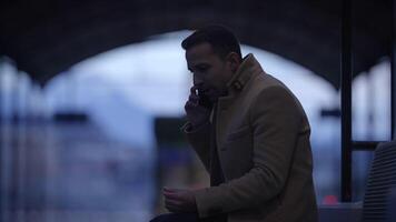 A person converses on the phone at dusk in an urban setting, generating a unique vibe video