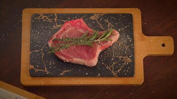 Fresh Raw Meat Displayed on a Chopping Board Garnished with Sprigs of Rosemary Herb video