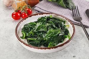 Spinach in a bowl with a knife and fork photo