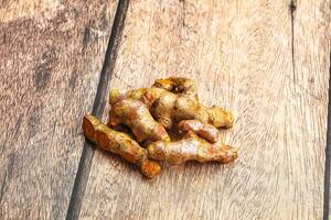 A pile of ginger on a wooden table photo