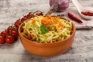 A bowl of coleslaw with carrots and tomatoes photo