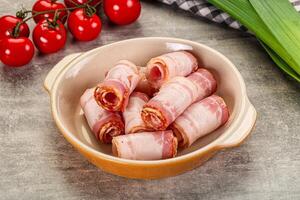 Bacon wrapped in bacon in a bowl on a table photo