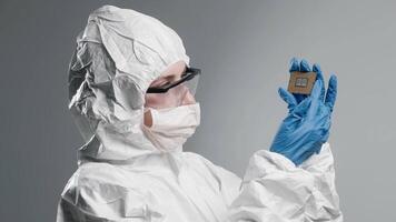 Presentation of new semiconductor microchip. Female Technician holding piece of technological wonder. Concept of modern technology and hardware development video