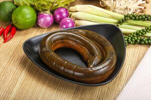 A plate with a snake in it and some vegetables photo