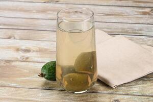 A glass of water with a lemon and lime in it photo
