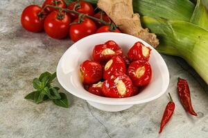 A bowl of tomatoes and corn on a table photo