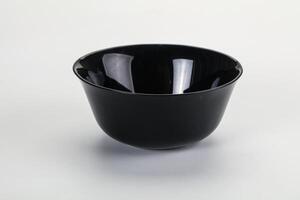 A black bowl on a white surface photo