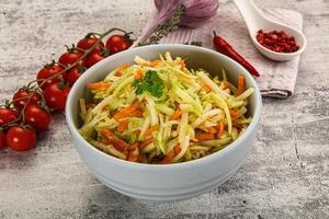 A bowl of salad with carrots and tomatoes photo