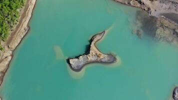 Drone view of the turquoise lake formed as a result of mining waste video