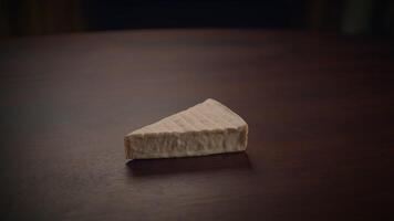 A beautifully displayed Artisan Cheese Piece elegantly placed on a rustic Wooden Table video