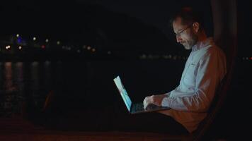 Engaging in a Focused and Professional Atmosphere During Nighttime Work by the Water video