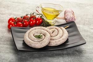 A plate with two sausage rolls and a bottle of olive oil photo