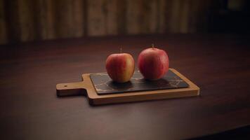 Fresh and Vibrant Red Apples Placed on a Rustic Wooden Cutting Board for Preparation video