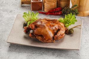 A chicken on a plate with vegetables and spices photo