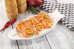 A white plate with shrimp and vegetables on it photo