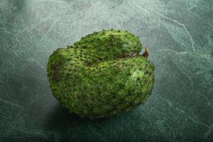 A green fruit on a green background photo