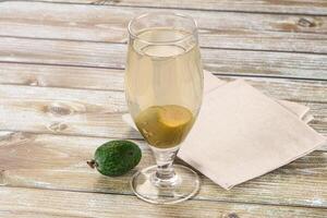 A glass of champagne with an avocado on a napkin photo