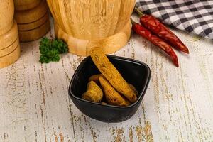 A bowl of carrots and a pepper on a table photo