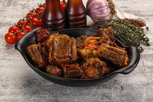 A bowl of meat with vegetables and tomatoes photo
