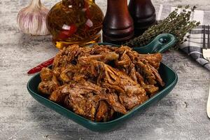 A bowl of pulled pork with garlic and herbs photo