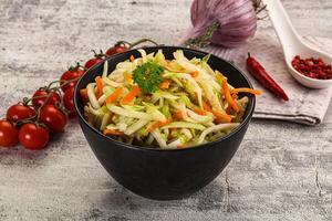 A bowl of vegetables and a spoon photo