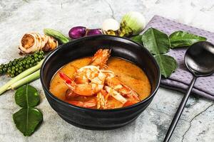 A bowl of soup with shrimp and vegetables photo
