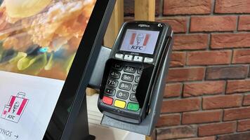 Warsaw, Poland. November 01, 2024. Payment terminal mounted on a stand in a fast food restaurant photo