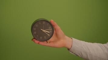 A vintage alarm clock on a green background offers nostalgic charm and eyecatching appeal video