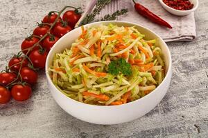 A bowl of salad with carrots and tomatoes photo