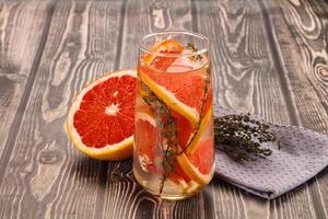 A glass of orange juice with a slice of grapefruit photo